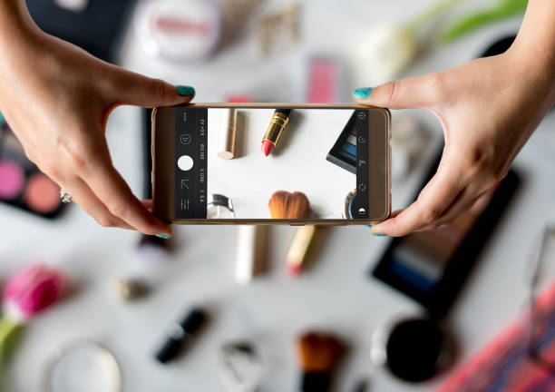 istock Woman Hands Using Mobile Phone Capture Photo with Cosmetics Background 683905046