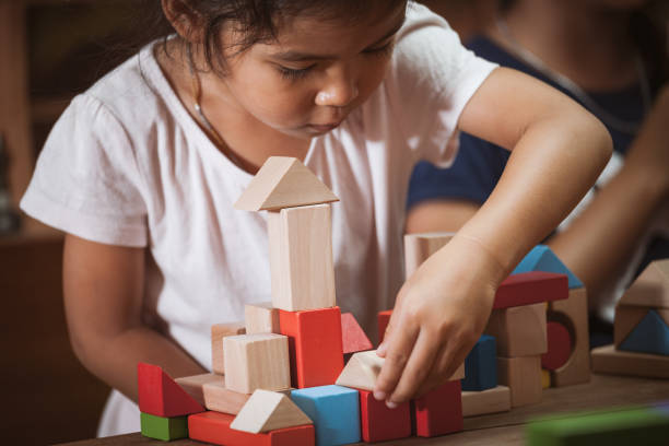 istock Focus on child's hand  playing with colorful wooden blocks 683910492