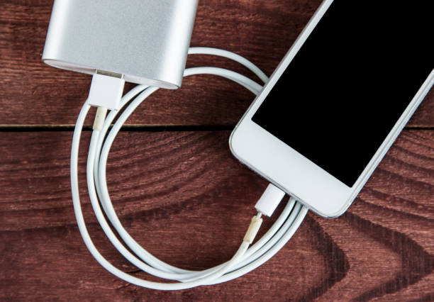 istock Broken Charging Cable With Phone and Powerbank On A Wooden Table 683911506