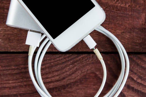 istock Broken Charging Cable With Phone and Powerbank On A Wooden Background 683911612