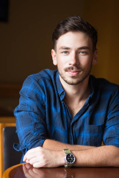 istock Closeup of Serious Handsome Young Man at Table 683911818