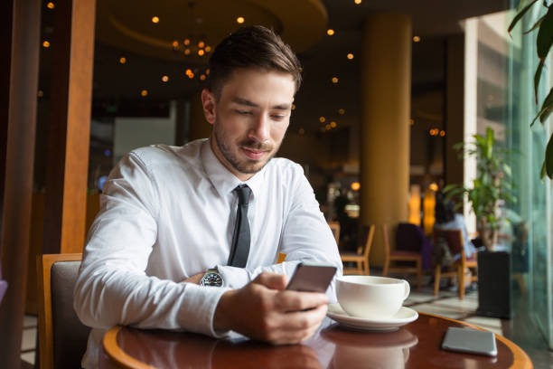 istock Content Attractive Business Man Texting in Cafe 683911848
