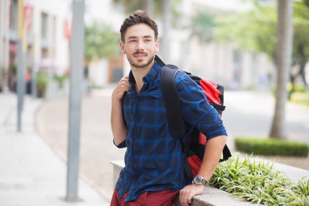 istock Content Handsome Man Sitting on Flowerbed in City 683911858