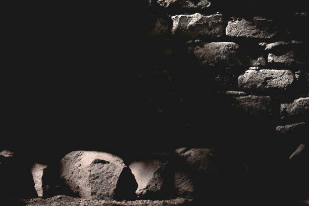Dark vintage brick wall in shadow with ray of light