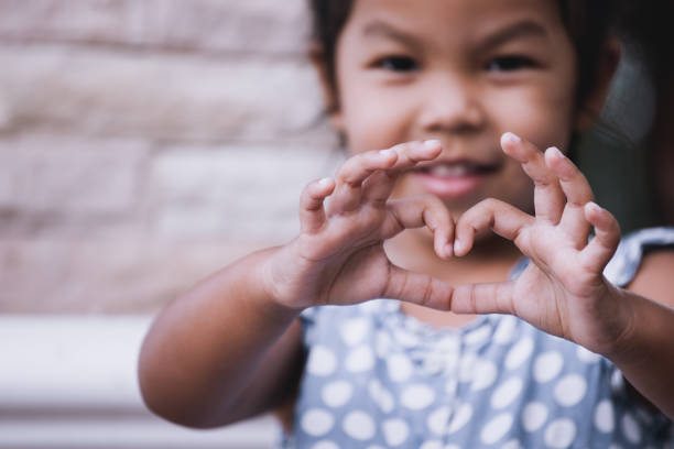 istock Asian little girl making heart shape with hands 683912292