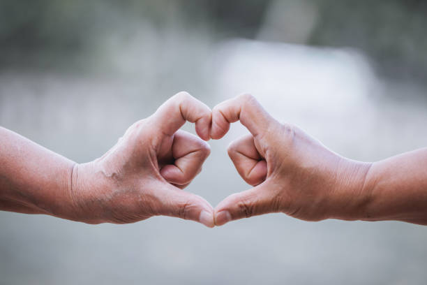 istock Two older women making heart shape with hands together 683914662