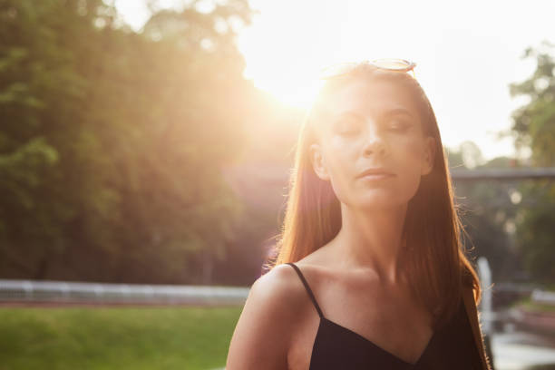 A woman closed eyes with sunlight