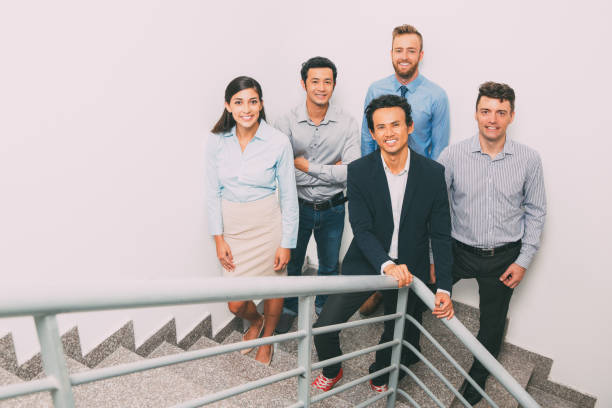 istock Smiling Business People Meeting on Office Stairway 683926376