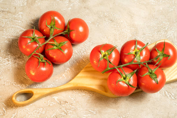 istock cluster of red ripe wet tomatoes on the table 683930922