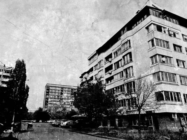 Black and white digital illustration of landscaped city neighborhood with buildings,street and cars
