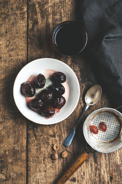 Pickled plum on a white plate over old wooden table