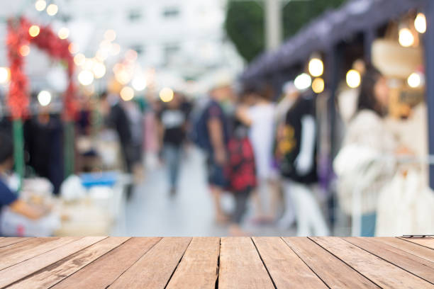 istock Shopping street blurred background on wood table 683944546