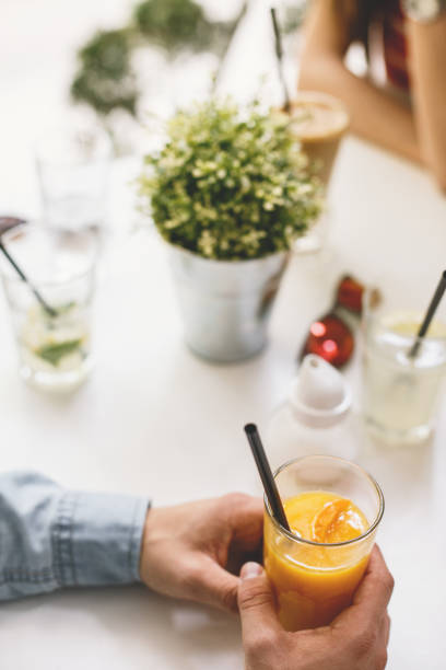 istock Hands holding a glass with orange juice 683948212