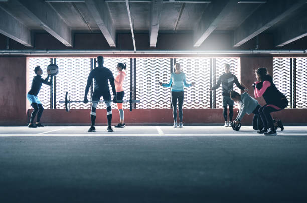 istock Group of sporty people training indoors. 683948758