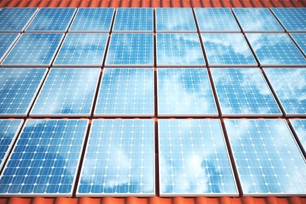 istock 3D illustration solar panels on a red roof reflecting the cloudless blue sky. Energy and electricity. Alternative energy, eco or green generators. Power, ecology, technology, electricity. 683951934