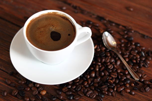 istock Cup of Coffee and Coffee Beans on wooden plank table 683956072