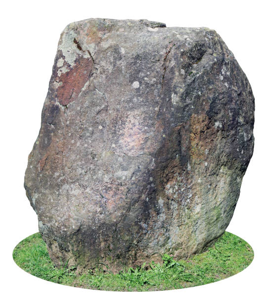 istock The big ancient mossy granite stone is established vertically on a forest green grass glade. Isolated on white with patch 683956720