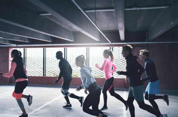 istock Group of active young friends urban running 683957530