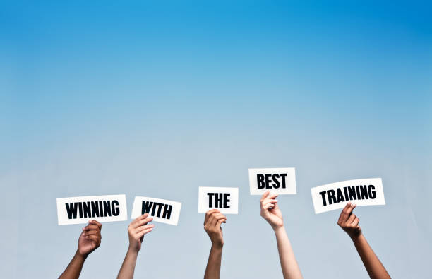 istock Hand-held signs read Winning with the best Training