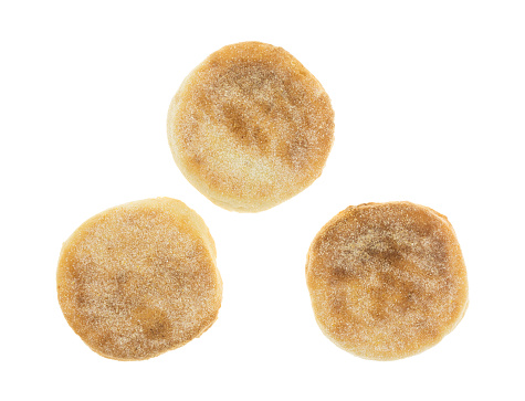 Top view of three freshly baked English muffins isolated on a white background.