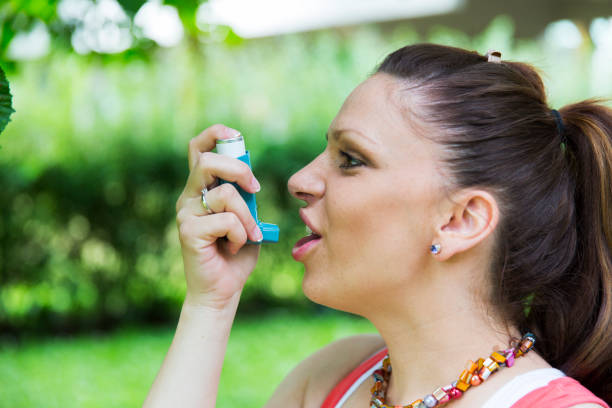 istock Young woman using asthmatic inhaler having asthma attack 683970330