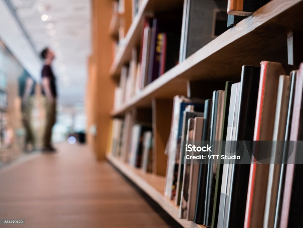 Blur People stand Book shelf in Public Library Blur People stand Book shelf in Public Library Education concept Library Stock Photo