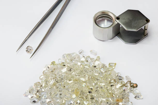 istock Diamonds, tweezers and loupe 683972286