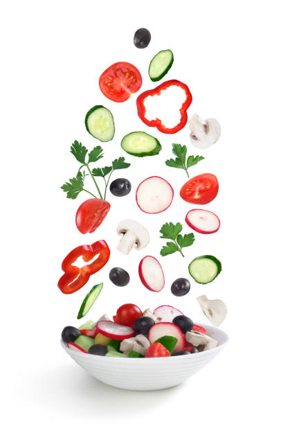 istock flying salad in plate isolated on white 683972924