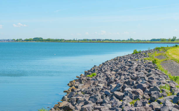 istock Dike of stones along a lake in spring 683973022