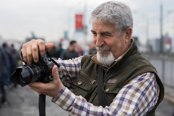 istock Senior man photographing with camera 683976356