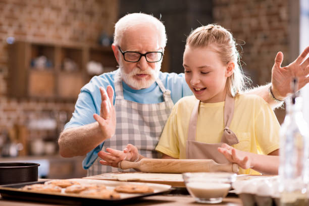 istock grandfather and granddaughter kneading dough 683976894