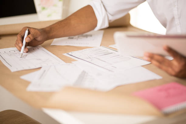 istock Male architect working on plans, close-up 683976922