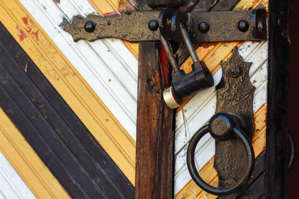istock Closed old rusty lock on a wooden door 683980570
