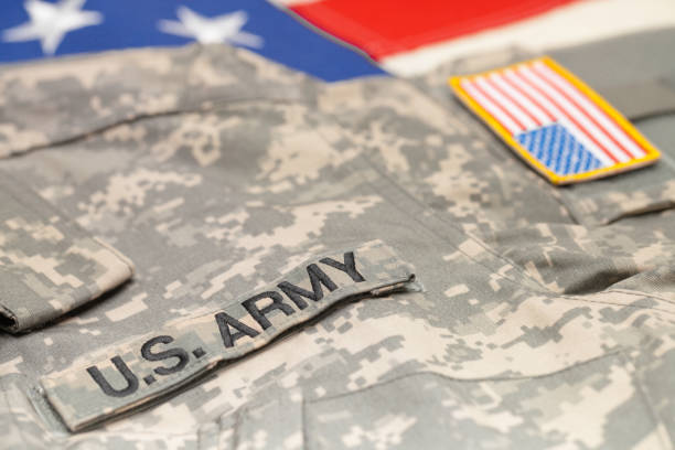 istock USA army uniform over US flag - studio shot 683980750