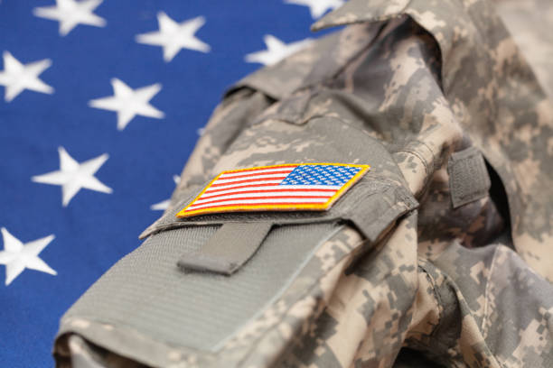 istock USA army uniform over national flag - studio shot 683980908