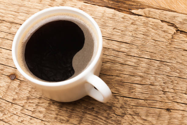 istock Cup of black coffee on old wooden table 683980976