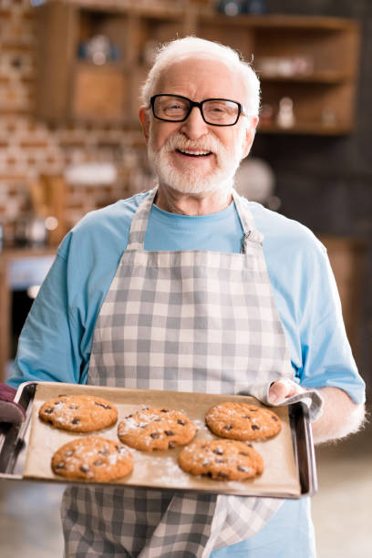 istock Senior man with cookies 683981286