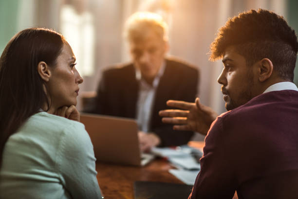 istock Young couple discussing while having a meeting with insurance agent. 683983388