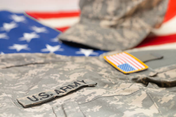 istock USA army uniform lying over national flag - studio shot 683983704