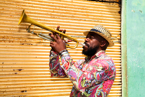 Cuban musician playing a trumpet in Havana, Cuba.
