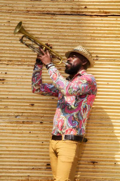 African musician playing a trumpet in Havana, Cuba.