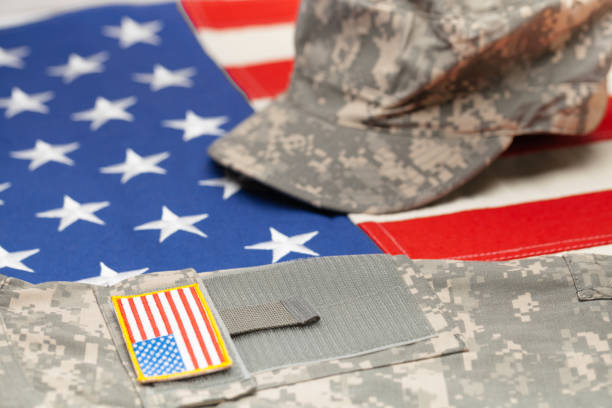istock USA flag with US military uniform over it - studio shot 683987318