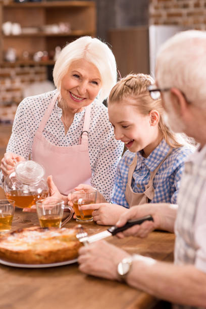 istock family drinking tea at home 683988296