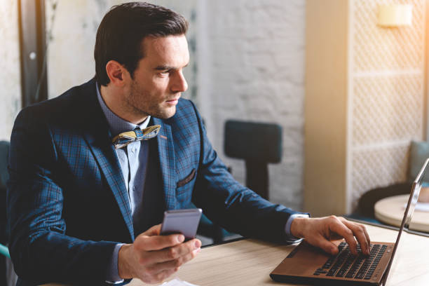 istock Composed businessman using laptop in room 683988410