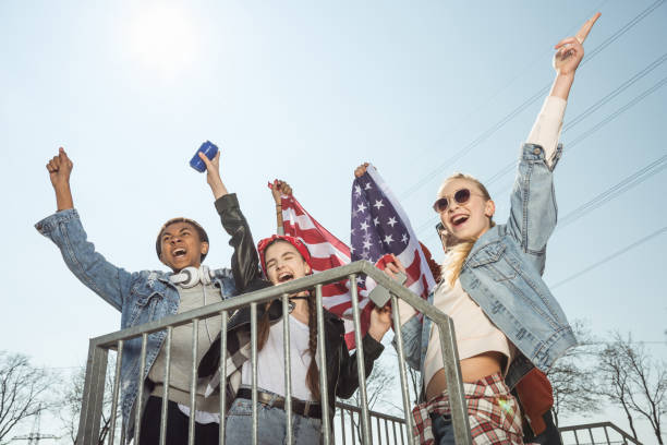 istock teenagers  waving american flag 683988432