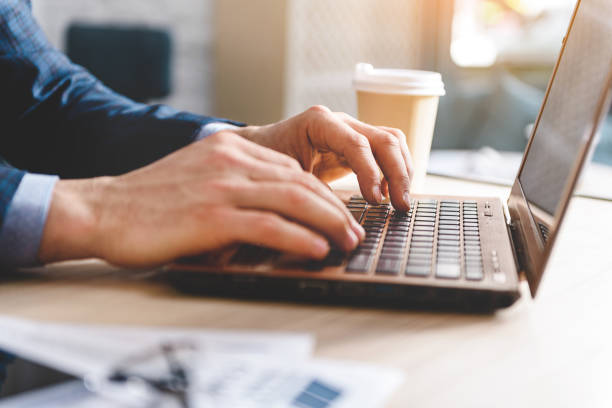 istock Man hands typing at laptop in room 683988532