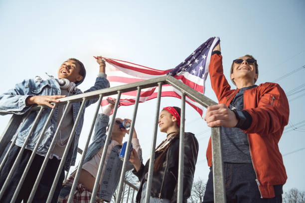 istock teenagers  waving american flag 683990758
