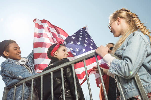istock teenagers waving american flag 683997366