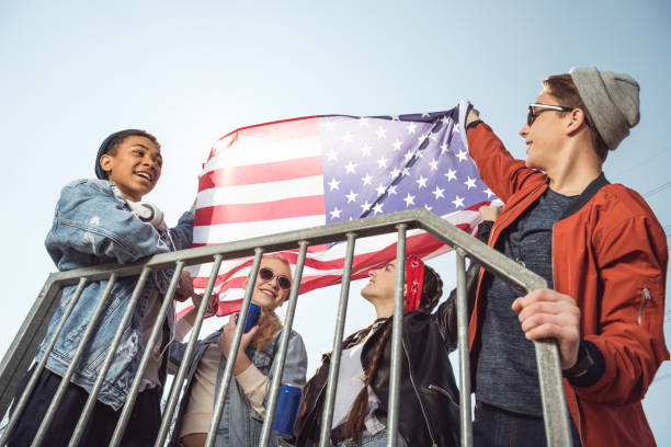 istock teenagers waving american flag 683997436