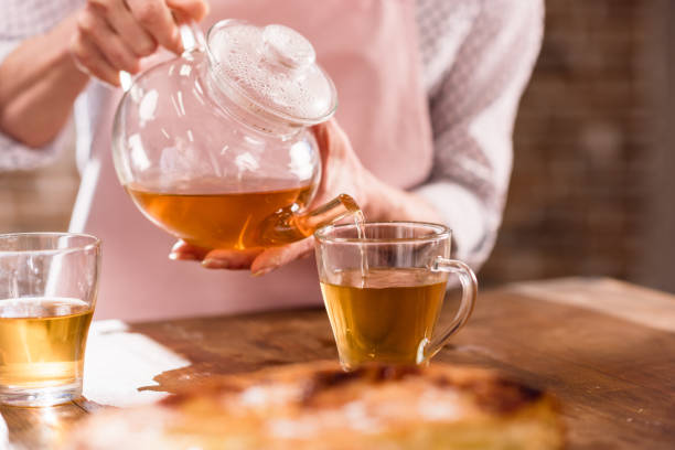 istock woman pouring hot tea 683997764